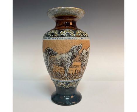 A footed vase with glazed foliate tube line bands on the top and bottom. The center band features incised pack of hounds on a