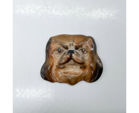 Molded as a Chinese toy dog head originally for a brooch pin; brown and dark brown coloration. Royal Doulton stamp. Issued: 1