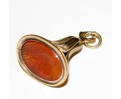 A yellow colour metal fob seal set with a carnelean intaglio of a Greek goddess