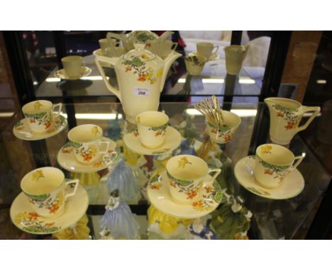 A Crown Ducal coffee service decorated with orange blossom, comprising six tea cups and saucers, sugar bowl, milk jug and cof