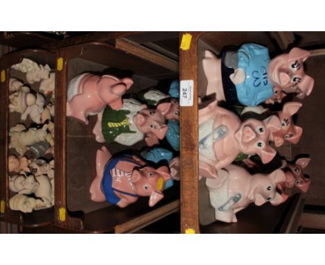 A collection of Wade 'Natwest Pigs' money boxes, and various other ceramic and resin figures of pigs