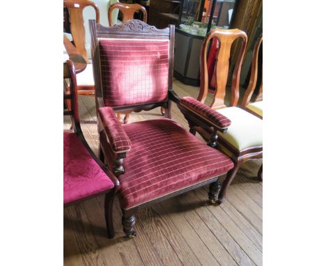 An Edwardian stained beech gentleman's armchair, the scroll carved top rail over a padded back, seat and arms on ring turned 