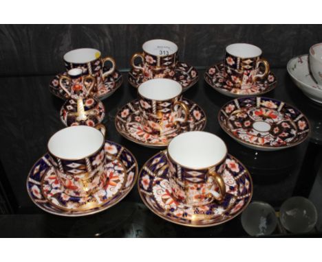 A set of six Royal Crown Derby Imari pattern coffee cans and saucers, another saucer and a Davenport miniature two handle Ima