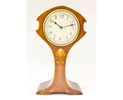 An Edwardian Art Nouveau style mahogany and boxwood strung mantel timepiece, the waisted case with mother of pearl inlaid tul