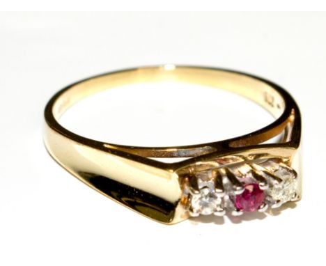 A three stone ruby and diamond ring set in 9 carat yellow gold