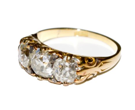 An 18 carat gold ring set with three old cut diamonds with a spread weight of approx 1 carat 25