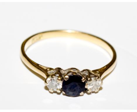 A small sapphire and diamond three stone ring set in 18 carat gold