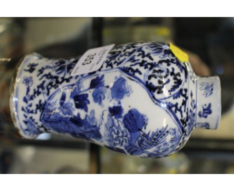 A Chinese blue and white vase, Kangxi style, of baluster form, the panels depicting birds above flowers, four character mark 