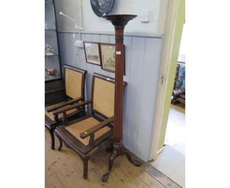 A mahogany torchere, the circular top and fluted tapering stem on a tripod base with ball and claw feet, 153cm high