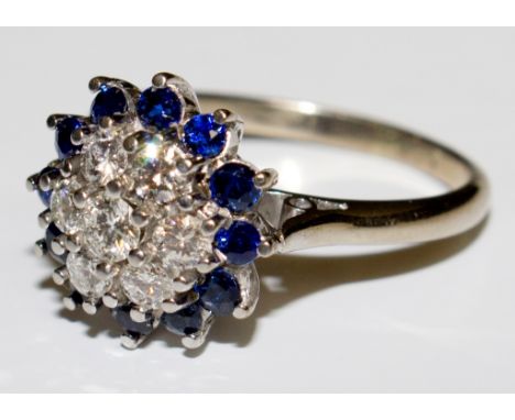 A fine quality diamond and sapphire cluster ring set in 18 carat white gold