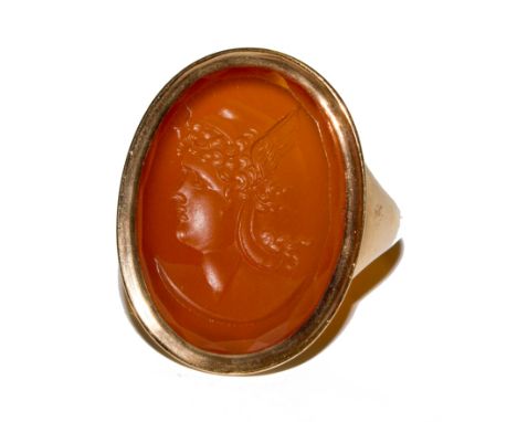 A gold colour ring set with a carnilian intaglio of a Greek godess