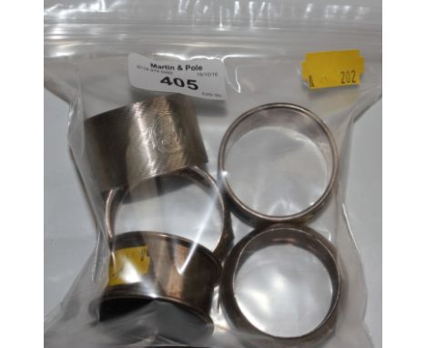 A collection of four silver napkin rings and an Indian napkin ring