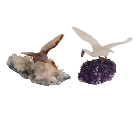 TWO HARDSTONE MODELS OF BIRDS IN FLIGHT  MODERN  The first a carved rock crystal swan, wings outstretched, with onyx and tour
