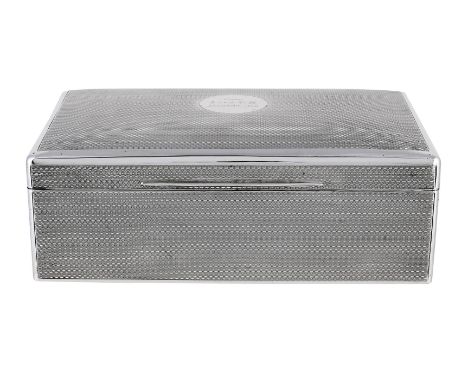 
	
		A SILVER MOUNTED RECTANGULAR CIGARETTE BOX
		MAKER&#39;S MARK OBSCURED, LONDON 1911
		With engine turned decoration, eng