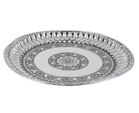 
	
		AN INDIAN SILVER COLOURED DISH
		UNMARKED
		Chased with flowers and foliage
		31cm diameter
		611g (19.65 oz)
		
		
		Co