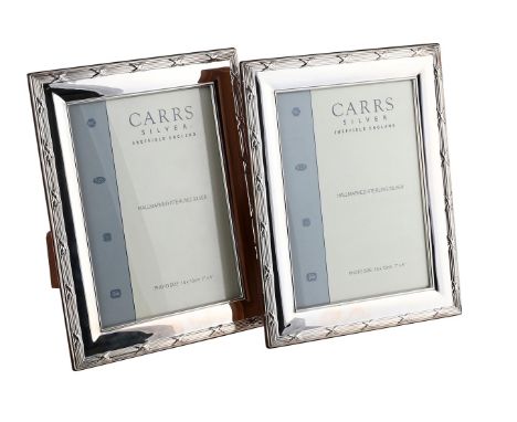 
	
		TWO SILVER MOUNTED PHOTO FRAMES
		CARR&#39;S OF SHEFFIELD, SHEFFIELD 2007
		With reed and stitch borders
		23cm high
		W