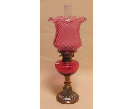 A cranberry glass oil lamp 