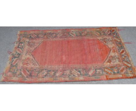 A rug of predominately blue and rust colours 