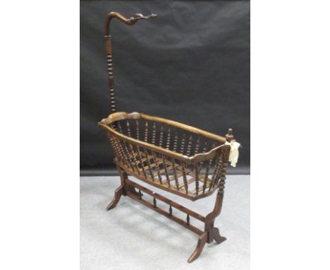 A 19th century mahogany cradle with bobbin turned supports 