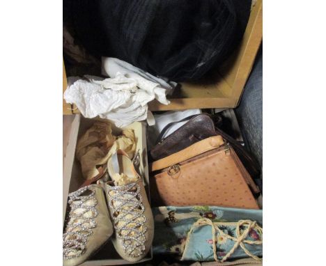 A collection of vintage dresses and accessories including gloves and hand bags 