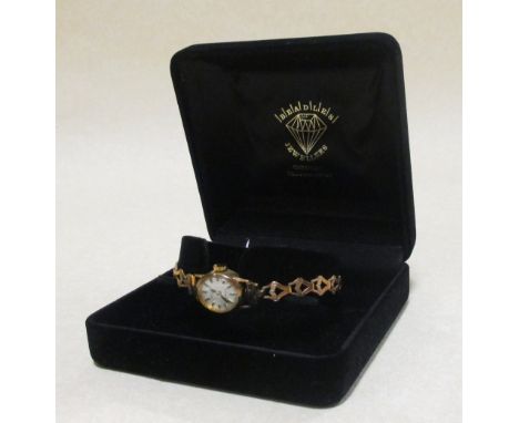 A lady's 9ct Rotary wristwatch, the oval dial with baton numerals, stamped 375 to case and strap, gross weight 10.8g 