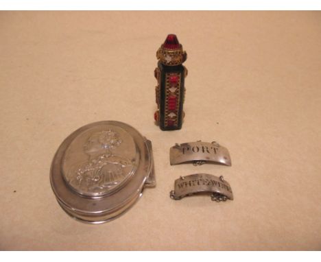 A red glass and mounted scent bottle and a white metal oval portrait snuff box, apparently unmarked, and two small wine label