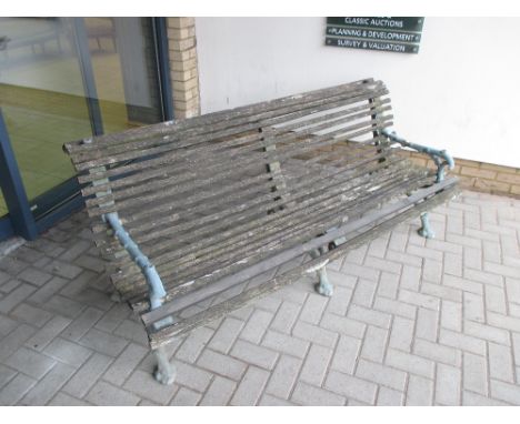 A cast iron garden bench with faux branch work frame 