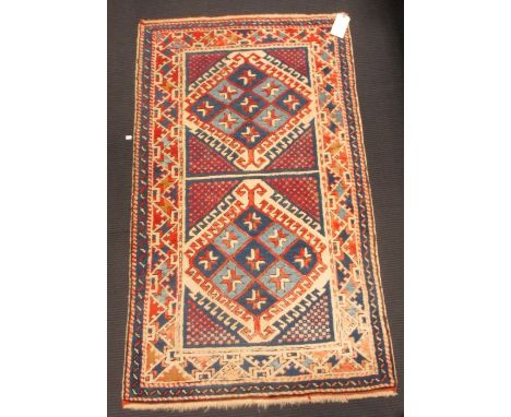 A small geometric wool rug on a cream ground, 160 x 94cm 