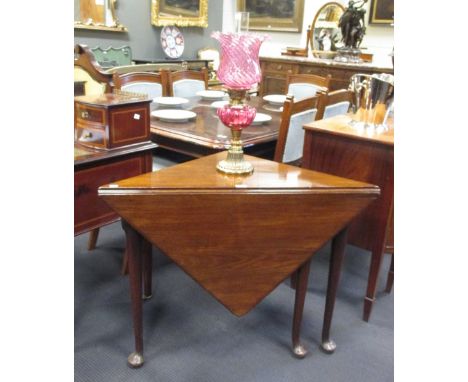 A George III mahogany drop leaf table with the triangular top opening on single gate together with a fireguard 