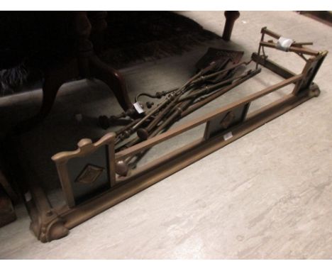 A brass fender and a wooden group of card players 