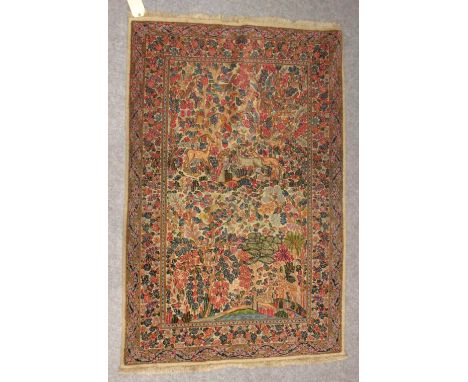 A Persian design pale ground rug with animals, birds and other motifs 