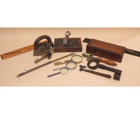A Victorian ebony and brass mounted scoring gauge, an ebony and brass parallel ruler, a boxwood parallel ruler, a small axe, 