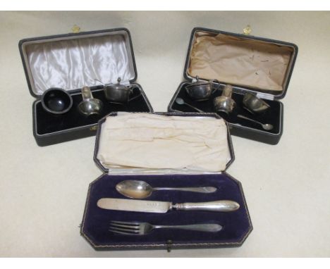 Two cased silver cruet sets and a cased silver knife, fork and spoon set 