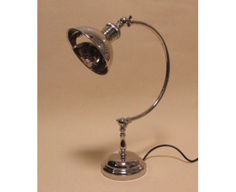 A nickel plated desk lamp on circular base 