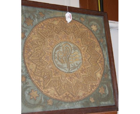 A 19th century Persian gold thread on silk worked Suzani panel, worked with script, floral sprays and symbols (silk distresse