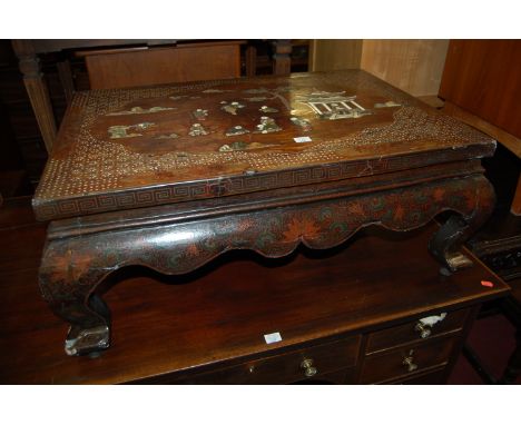 A late 19th century Japanese chinoisserie lacquered and Shibyama low occasional table, the top inlaid in hardstones with figu