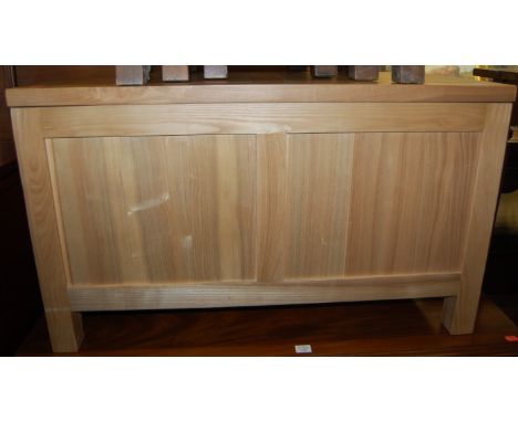 A modern light oak two panelled hinge top blanket box