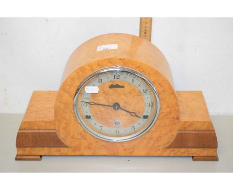 An early 20th Century mantel clock in birdseye maple veneered case