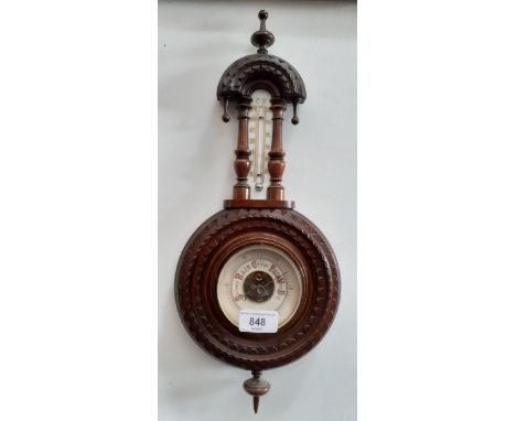 A late 19th century carved oak barometer. 