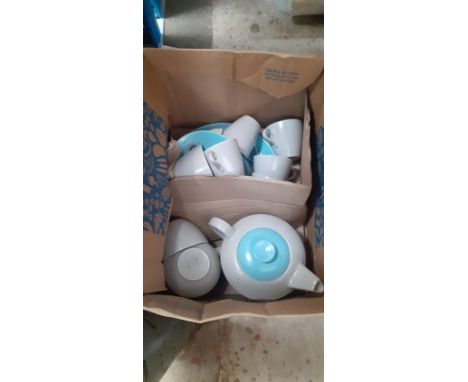 A box containing a Poole tea set. 