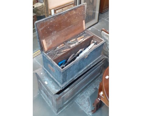 A carpenter's tool chest with fitted interior containing a number of old hand tools, together with an old oak chest.Top Chest