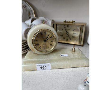 An onyx clock on a base and a brass carriage clock 
