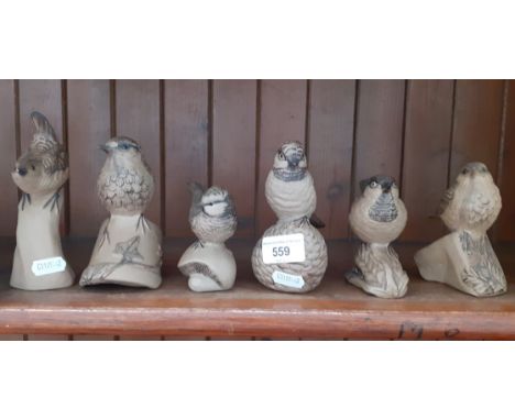 Six Poole Pottery birds, one as found. 