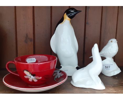 Various items of Poole Pottery including Daisy Chain cup and saucer, a penguin, a robin and a seal. 