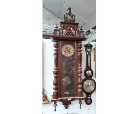 A large walnut case Vienna wall clock with keyCurrently in working order (but sold with no guarantees)