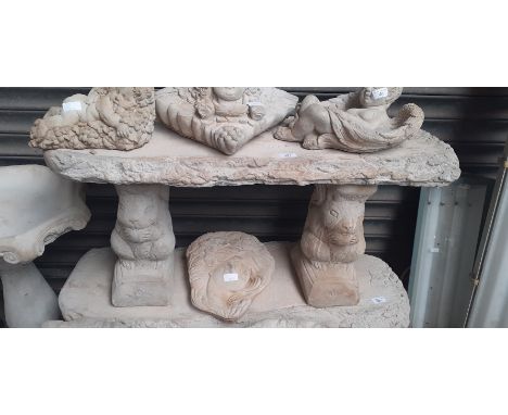 A log effect concrete bench on squirrel plinths 