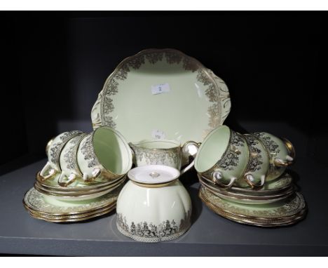 A Queen Anne part tea service No4322 in pale green and gilt