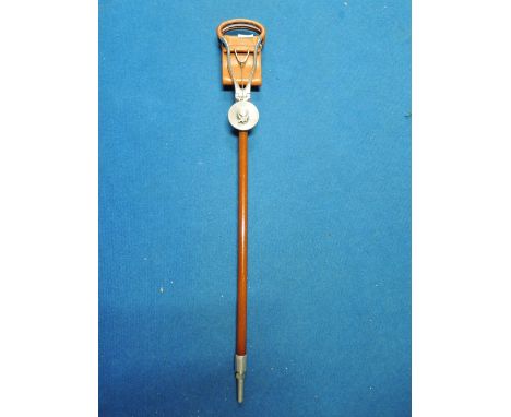 A shooting stick with leather seat