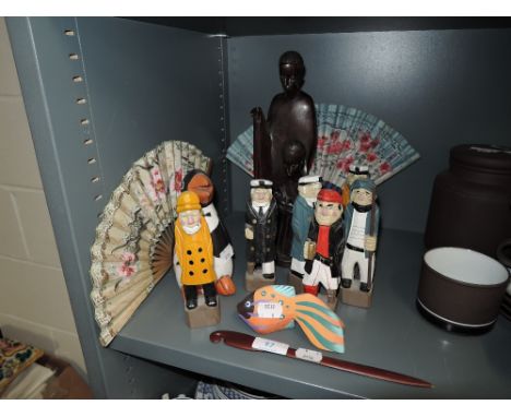 A selection of carved wood figures including maritime and African art