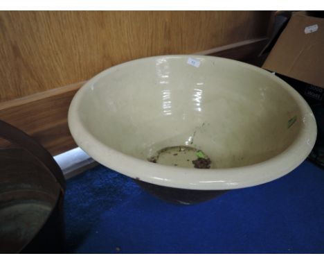 A large ceramic or cream butter bowl